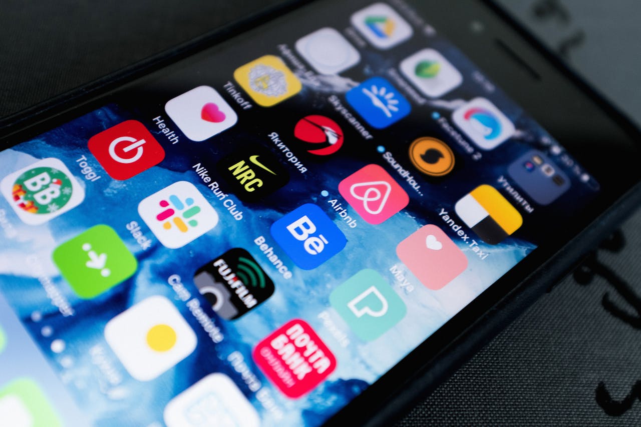 creative-02 Detailed view of smartphone displaying multiple app icons on screen, highlighting technology use.